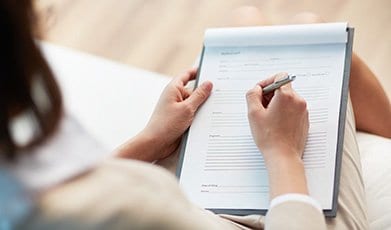 Patient reviewing and filling out a form